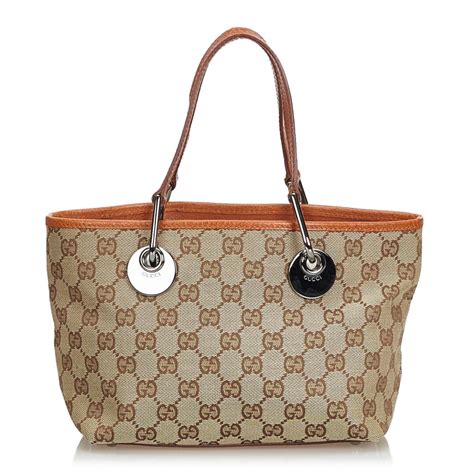 gucci light brown monogra on top and ends of handbag|vintage Gucci brown leather handbag.